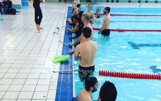 Go Freediving Surf Survival Course students in pool listening to Heather cc